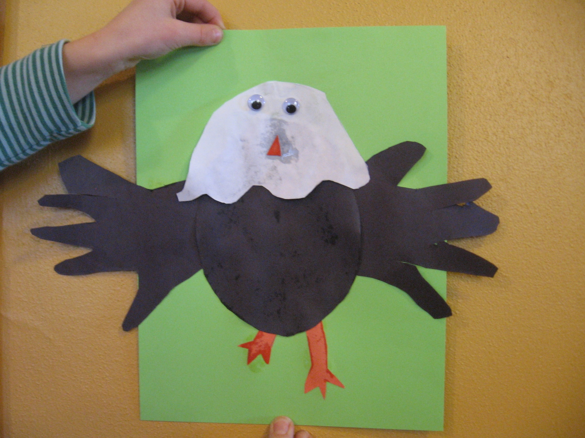 child with letter E handprint eagle