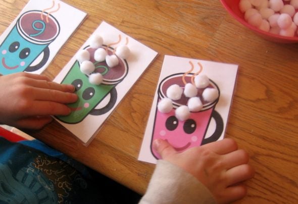 children placing marshmallows on cards