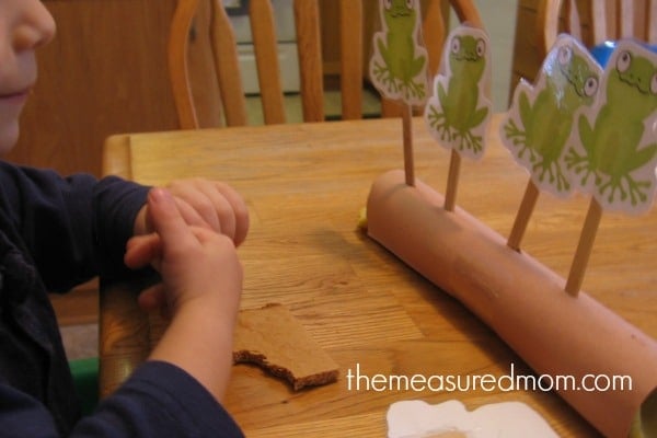 child playing with frog cards (five little speckled frogs)