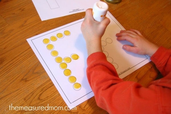child stamping do-a-dot marker on letter F worksheet