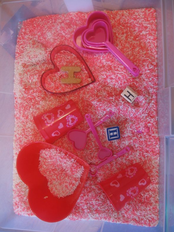 colored rice letter H sensory bin