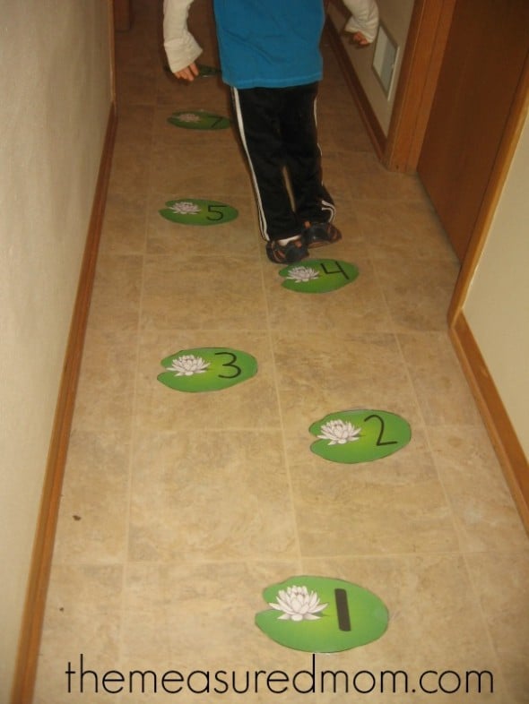 child jumping on numbered lily pad cards