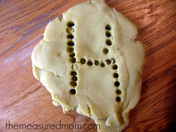 letter H made with holes in playdough