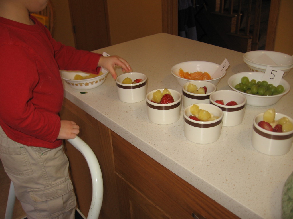 child making fruit salad