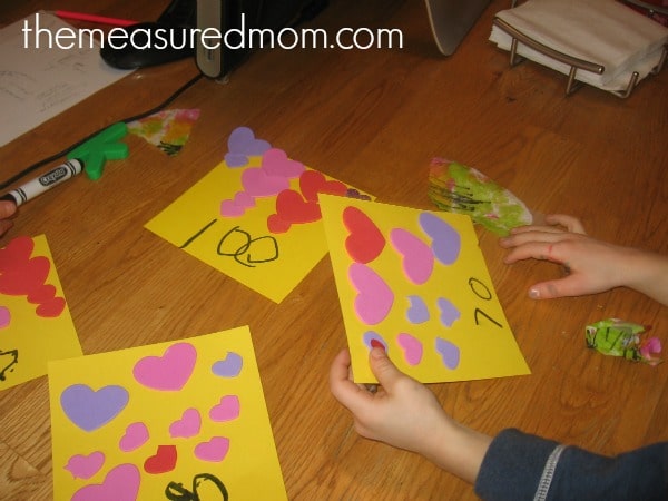 child reading number on paper