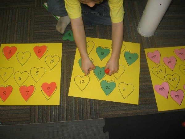 child placing heart on paper