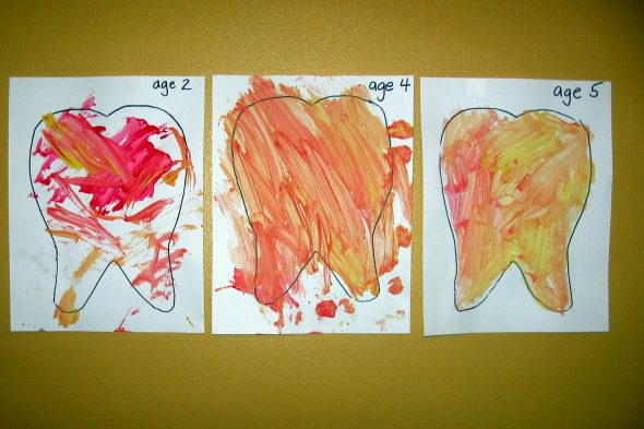 letter T painted teeth with toothbrushes