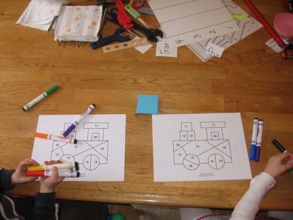 children with coloring pages and markers