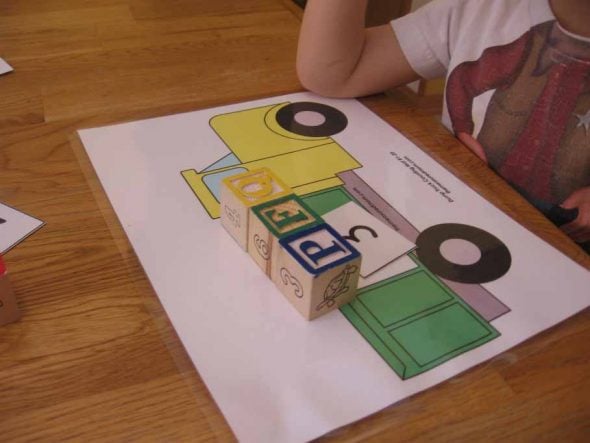 child with counting mat with blocks