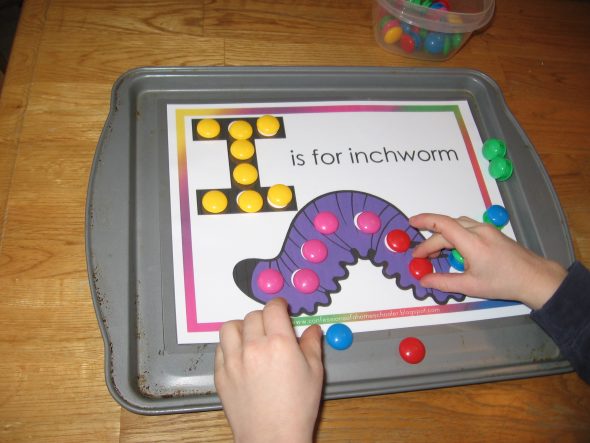 child placing magnets on letter I worksheet
