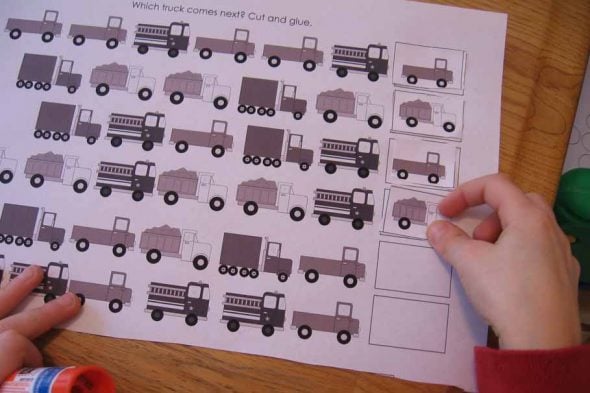 child placing card on truck pattern strips