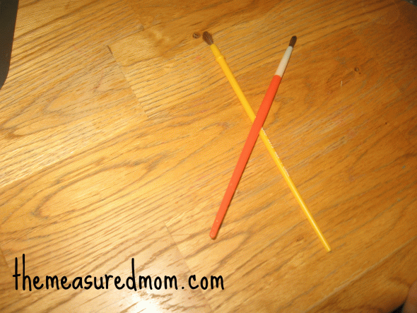 letter X with paintbrushes