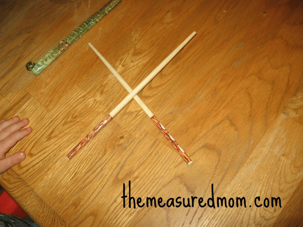 child with letter X with chopsticks