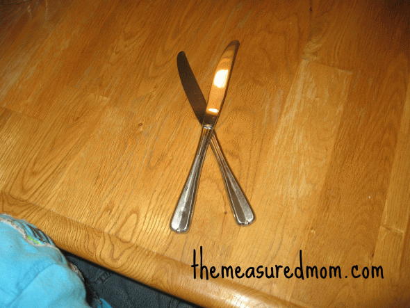 child with letter X with flatware