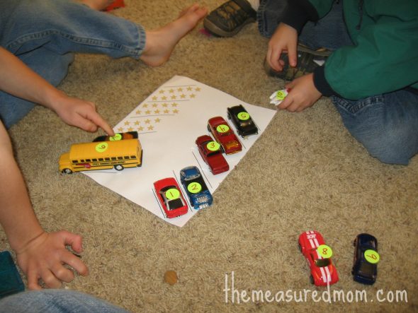 children matching numbered cars to the parking lot spaces