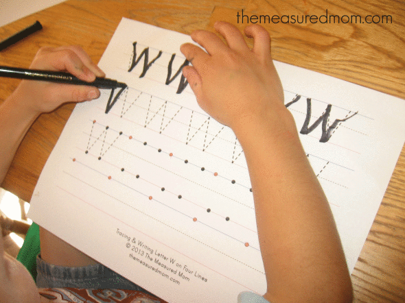 child writing on letter W worksheet