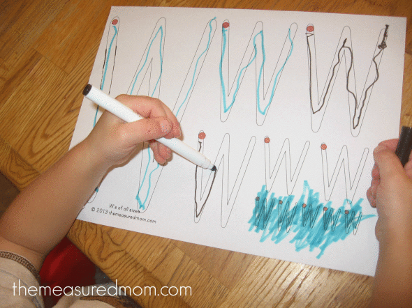 child writing on letter W worksheet