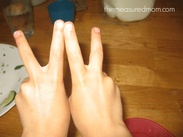 child making letter W with fingers