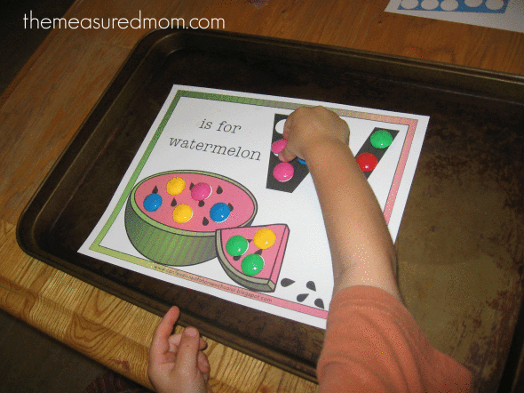 child placing power magnets on W is for watermelon worksheet