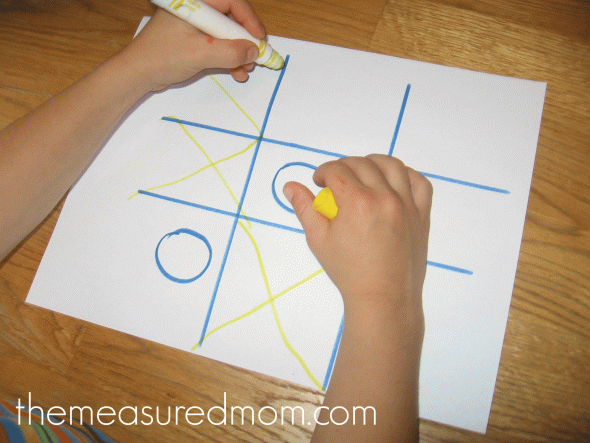 child playing tic-tac-toe letter X