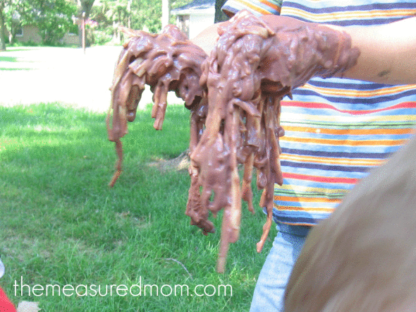 child playing with linguine and chocolate pudding