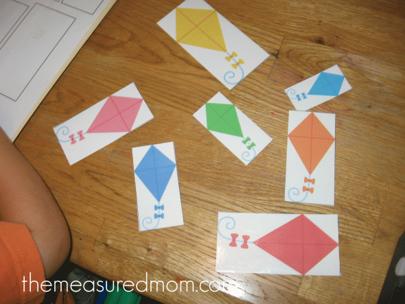 child playing free kite file folder game - color matching and size sort 