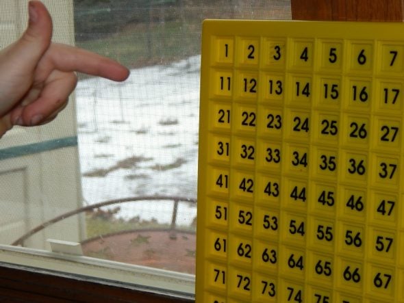 child with a math board